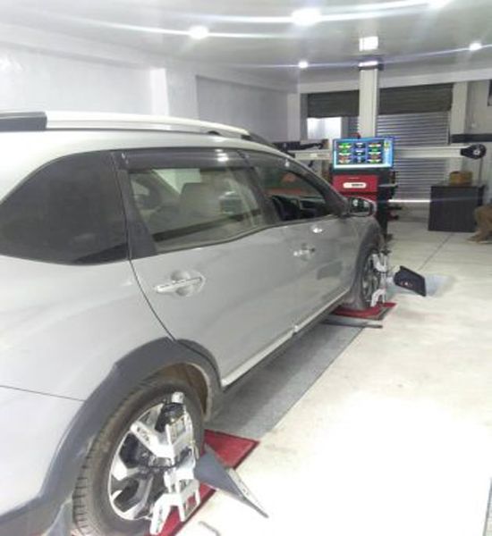wheel balancing of a car in workshop by united equipment